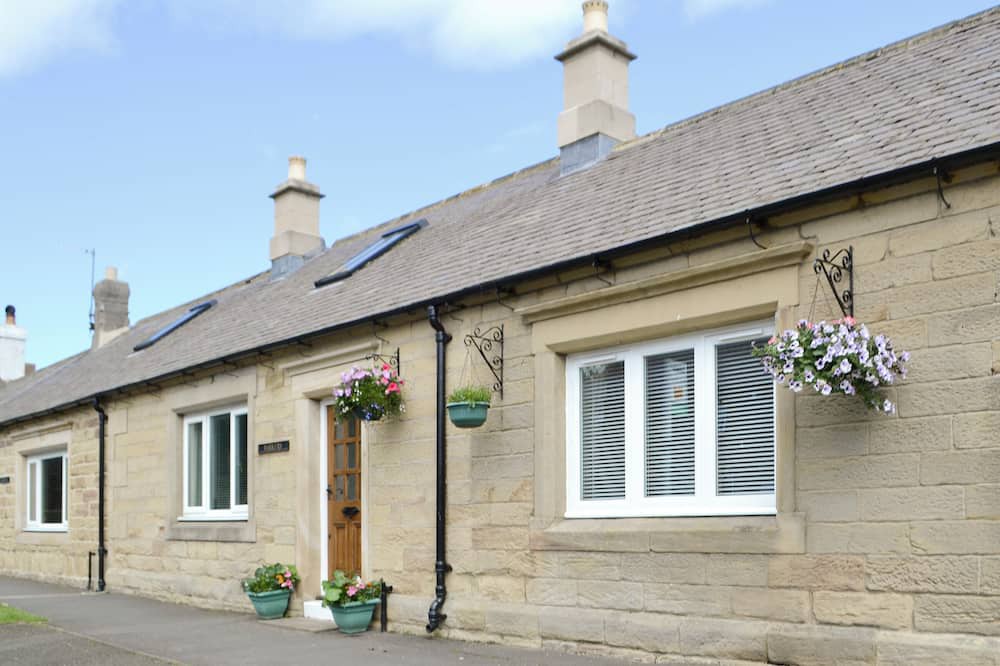 Woodhorn Cottage | Lovely property with an open staircase leading to 2 bedrooms and a bathroom.