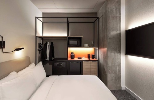 Brossard Hotel | Enjoy Functional Elegance in Spacious Room w/Kitchenette + Dining Table