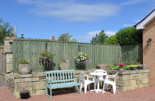 Woodhorn Cottage | Lovely property with an open staircase leading to 2 bedrooms and a bathroom.