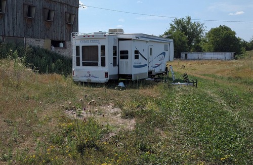 Asphodel-Norwood House | Serenity Lane Farm Stay: a trailer next to a barn full of farm animals