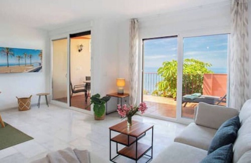 La Capellania Apartment | This seaside apartment is perfect for relaxation with its terrace offering sea views and soothing wave sounds. It features two bedrooms, two fully equipped bathrooms, a spacious living room, and a kitchen. Enjoy meals or sunbathe on the loungers