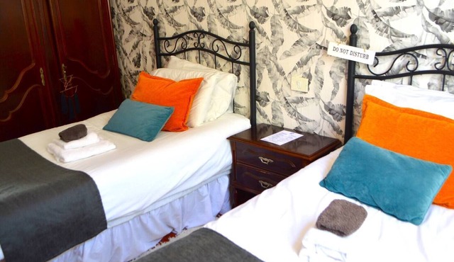This room has two single beds with an en-suite bathroom. The room has views of the village square.